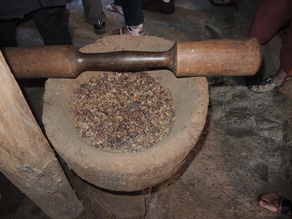 Wooden coffee pounder.